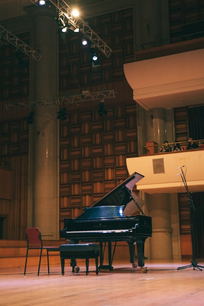 Black Grand Piano Standing on a Concert Hall Stage