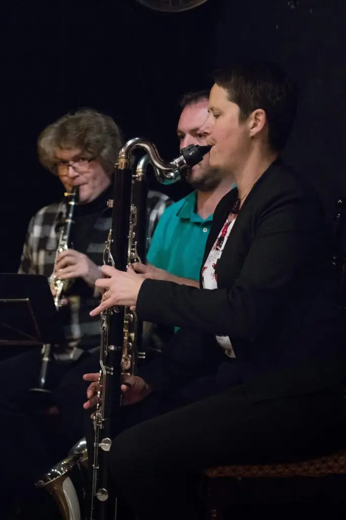 a group of men playing instruments in a dark room